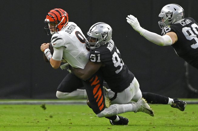 Las Vegas Raiders defensive end Yannick Ngakoue (91) sacks Cincinnati Bengals quarterback Joe Burrow (9) during the first half of an NFL football game, Sunday, Nov. 21, 2021, in Las Vegas.


