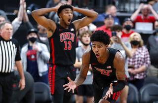 UNLV Rebels guard Keshon Gilbert (10) and Bryce Hamilton (13) react as Gilbert is called for a foul on Wichita State Shockers guard Tyson Etienne with 3.4 seconds left in the second half of a game in the Roman Main Event basketball tournament at T-Mobile Arena Sunday, Nov. 21, 2021.