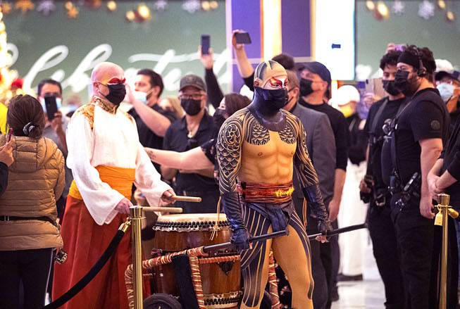 A drummer arrives in the lobby for a pop-up performance in the hotel lobby celebrating the return of KA by Cirque Du Soleil at MGM Grand Wednesday, Nov. 24, 2021.
