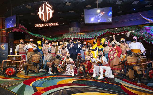 KA cast members and Cirque Du Soleil executives pose in front of the KA Theatre during a pop-up performance in the hotel lobby celebrating the return of KA by Cirque Du Soleil at MGM Grand Wednesday, Nov. 24, 2021. Executives from left: Eric Grilly, senior vice president of resident shows division, Stephane Lefebvre, COO of Cirque Du Soleil, and Gabriel De Alba, managing director and partner of the Catalyst Capital Group.