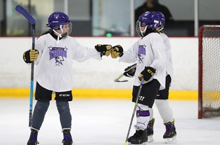 Las Vegas Storms Finley Gardner, left, (24) and captain Nyna Cruchet (6) bump gloves after a play during practice at the Las Vegas Ice Center Wednesday, Dec. 1, 2021.The Storms 12-and-under girls team recently won a tournament in California, where they beat the other youth hockey program in town, the Vegas Jr. Golden Knights.
