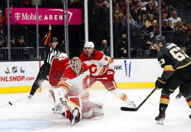 Vegas Golden Knights right wing Evgenii Dadonov (63) scores past Calgary Flames goaltender Jacob Markstrom (25) during the third period of an NHL hockey game at T-Mobile Arena Sunday, Dec. 5, 2021. The Golden Knights beat the Calgary Flames 3-2. 