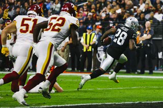 Las Vegas Raiders running back Josh Jacobs (28) runs the ball in for a touchdown during the second half of an NFL football game against the Washington Football Team at Allegiant Stadium Sunday, Dec. 5, 2021.