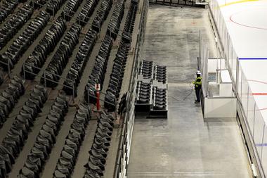 A construction crew member moves the seating during a media preview tour of The Dollar Loan Center, home of the Henderson Silver Knights and the Vegas Knight Hawks, Monday, Dec. 6, 2021.