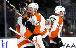 Philadelphia Flyers defenseman Justin Braun (61) celebrate with Philadelphia Flyers goaltender Carter Hart (79) after beating the Vegas Golden Knights, 4-3, in an NHL hockey game at T-Mobile Arena Friday Dec. 10, 2021. Philadelphia Flyers defenseman Rasmus Ristolainen (70) is at right.