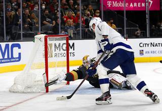Vegas Golden Knights goaltender Laurent Brossoit (39) makes a diving save against Tampa Bay Lightning right wing Corey Perry (10) during the second period of an NHL hockey game at T-Mobile Arena Tuesday, Dec. 21, 2021.