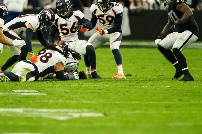 Denver Broncos defensive lineman Mike Purcell recovers a fumble from ...
