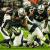 Las Vegas Raiders running back Josh Jacobs (28) gets tackled during a play in the 4th quarter of their game against the Denver Broncos at Allegiant Stadium Sunday, Dec. 26, 2021. The Raiders defeat the Denver Broncos 17-13.