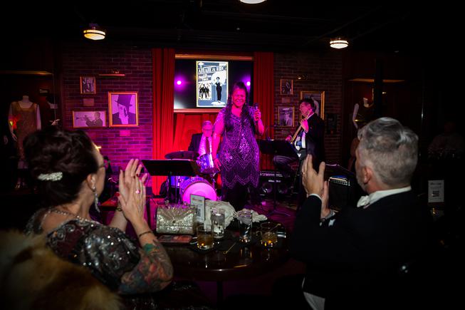 Tammy and Mark Musselwhite enjoys a performance by Amanda King and her Prohibition Band during the New Year's Eve 2022 party at The Mob Museum's Underground speakeasy Friday Dec. 31, 2021.