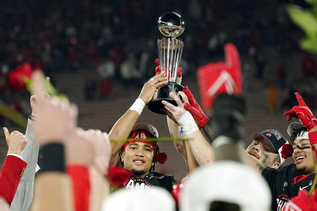 Ohio State quarterback C.J. Stroud holds the game winner's trophy after defeating Utah during the Rose Bowl NCAA college football game Saturday, Jan. 1, 2022, in Pasadena, Calif. 

