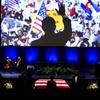 A person stands next to the flag-draped casked of former Senate Majority Leader Harry Reid as an image of Reid campaigning is displayed after a memorial service for Reid at the Smith Center in Las Vegas, Saturday, Jan. 8, 2022. 