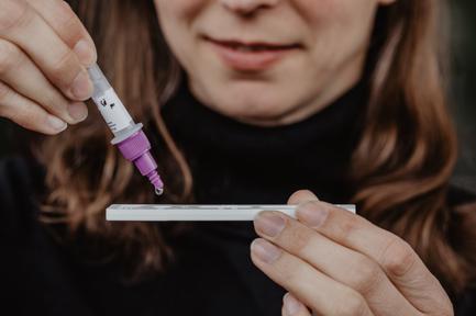 A woman tests herself for COVID-19 using a self-test at home. A viral video on social media that shows a home experiment to produce false positive results on at-home tests has drawn rebukes from medical professionals in Las Vegas and internationally.