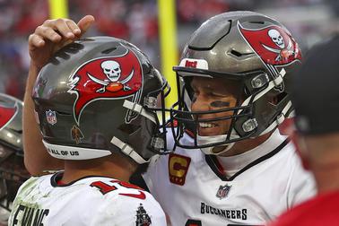 Tampa Bay Buccaneers quarterback Tom Brady, right, celebrates with wide receiver Mike Evans after Evans caught a touchdown pass against the Philadelphia Eagles during the second half of an NFL wild-card football game Sunday, Jan. 16, 2022, in Tampa, Fla. 



