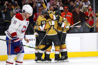 Montreal Canadiens defenseman Ben Chiarot (8) skates by Vegas Golden Knights as they celebrate a goal by Vegas Golden Knights center Jonathan Marchessault (81) during the third period of an NHL hockey game at T-Mobile Arena Thursday, Jan. 20, 2022.
