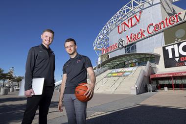 Matt Styck, left, content creator for UNLV Athletics, and Ricky Witt, director of new media and video production, pose in front of the Thomas & Mack Center at UNLV Wednesday, Feb. 9, 2022.