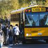 Students board a school bus Friday, Feb. 11, 2022.