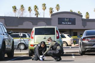 Investigators collect a blood sample at a crime scene in the Sahara Commercial Center District Saturday, Feb. 26, 2022.