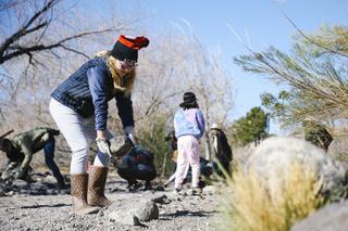 Lauren Walter, 10, volunteer for Project GREEN: Friends of Pittman Wash, places a rock during a trail restoration at Pittman Wash in Henderson Saturday, Feb. 26, 2022.