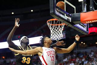 UNLV Rebels guard Bryce Hamilton (13) lays up the ball past Wyoming Cowboys forward Graham Ike (33) during an NCAA basketball game at the Thomas & Mack Center Wednesday, March 2, 2022.