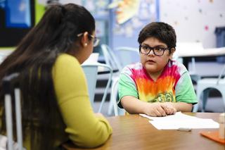 Jerania Mancilla, a special education assistant teacher who is taking part in CCSDs Paraprofessionals Pathway Program, helps Daniel Gomez Romero, 4th grade, with his handwriting at C.C. Ronow Elementary School Thursday, March 3, 2022.