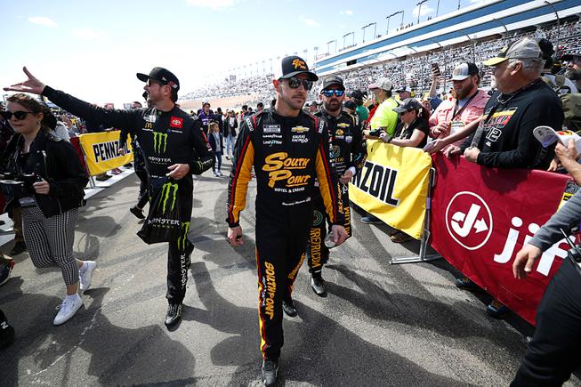 NASCAR Cup Series driver Kurt Busch, left, and Daniel Hemric head to driver introductions during the 25th annual Pennzoil 400 NASCAR Cup Series race at the Las Vegas Motor Speedway Sunday, March 6, 2022. Driver Martin Truex Jr. is at back left.