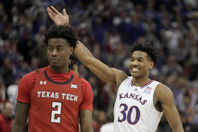 Kansas guard Ochai Agbaji (30) celebrates after an NCAA college basketball championship game against Texas Tech in the Big 12 Conference tournament in Kansas City, Mo., Saturday, March 12, 2022. Kansas won 74-65.