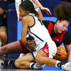 Arizona forward Sam Thomas (14) and UNLV forward Khayla Rooks (20) fall to the court after Thomas tried to steal the ball during a first-round game in the NCAA women's college basketball tournament Saturday, March 19, 2022, in Tucson, Ariz. 