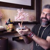 Vladi Bergman, founder and CEO of Las Vegas-based Karma and Luck, poses with a rose quartz gemstone tree in his store Karma and Luck at The Shoppes at Mandalay Bay Friday, March 25, 2022. Bergman plans to also sell about 1,000 blue-and-yellow (lapis and citrine) gemstone trees, emblematic of the Ukrainian flag, for $99 each, with 100 percent of sales to be donated to Doctors Without Borders.