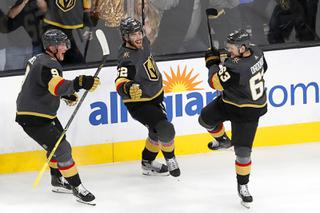 Vegas Golden Knights right wing Evgenii Dadonov (63) celebrates his goal in overtime with Jack Eichel (9) and Dylan Coghlan (52) during an NHL hockey game against the Chicago Blackhawks at T-Mobile Arena Saturday, March 26, 2022. The goal Golden Knights a 5-4 win over the Blackhawks.