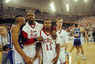 UNLV's Anderson Hunt (12) and unidentified teammates leave the floor after losing to Duke in the NCAA national semi-final game in Indianapolis, March 30, 1991.  Duke defeated UNLV by a score of 79-77.  (AP Photo/Al Behrman)