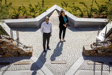 Jay Poster, founder and general manager of King David Memorial Chapel and Cemetery and Celena DiLullo, president of Palm Mortuaries, pose for a photo at the Holocaust Memorial Plaza at King David Memorial Chapel and Cemetery Thursday, April 21, 2022.