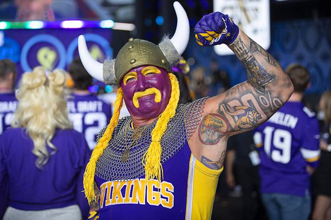 Minnesota Vikings fan Syd Davy shows off his 100% Viking tattoo during the NFL football draft Thursday, April 28, 2022.