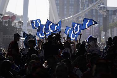 Indianapolis Colts fans wave flags during the second round of the NFL football draft Friday, April 29, 2022, in Las Vegas. (AP Photo/Jae C. Hong)