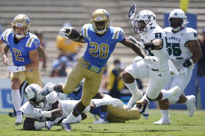 UCLA Bruins running back Brittain Brown (28) runs the ball during the first half of an NCAA college football game against the Hawaii Warriors Saturday, Aug. 28, 2021, in Pasadena, Calif.