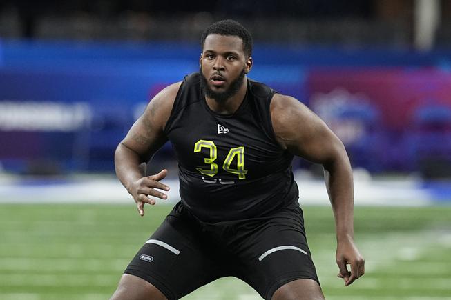 Ohio State offensive lineman Thayer Munford Jr. runs a drill during the NFL football scouting combine, Friday, March 4, 2022, in Indianapolis.