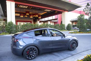 A Tesla Model Y, one of the rental vehicles available from EVolve Tesla Rentals, is shown in a porte cochere at Resorts World, Tuesday, May 3, 2022.