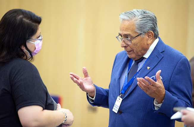 Candidate Fernando Romero talks with a woman during a candidate ...