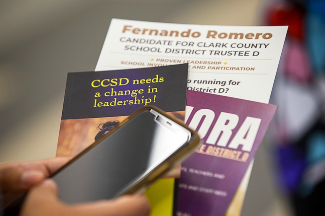 A woman gathers campaign literature during a candidate forum for ...