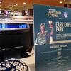 A sign bearing an advertisement for Caesars Entertainment's sports betting operation sits near a sports betting terminal in the sports betting lounge at the Tropicana casino in Atlantic City N.J. on Thursday, May 12, 2022.