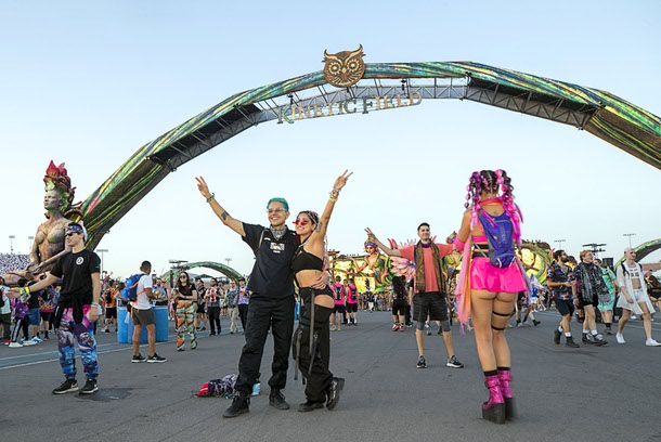 Jesus Aguilar and Vila Vasquez of Los Angeles pose by the entrance to Kinetic Field during the first night of EDC Las Vegas 2022 at the Las Vegas Motor Speedway Friday, May 20, 2022.