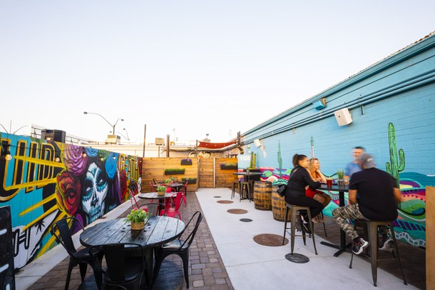 People have drink on the patio at Horse Trailer Hideout, downtown Friday, May 20, 2022.