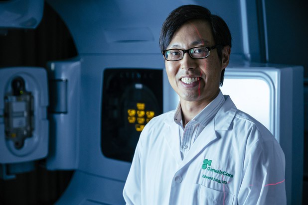 Radiation Oncologist Edward Jung, MD poses for a photo in front of a Varian IX Linear Accelerator at GenesisCare in Henderson Tuesday, May 24, 2022.