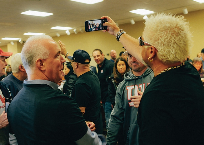 Guy Fieri works the selfie circuit at a charity event for New Jersey veterans April 1, 2022, in Port Monmouth, N.J.