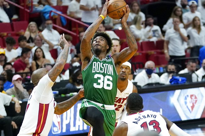 Boston Celtics guard Marcus Smart drives to the basket as Miami Heat forward P.J. Tucker (17) defends during the second half of Game 7 of the NBA basketball Eastern Conference finals playoff series, Sunday, May 29, 2022, in Miami. 

