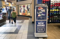 A couple passes by a help wanted sign at the Locker Room in the Las Vegas Premium Outlets South shopping mall Thursday, June 2, 2022. A new report issued Thursday, July 16, 2026, shows the number of seasonally adjusted nonfarm jobs in Nevada rose to 1,614,100.