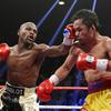 Floyd Mayweather Jr., left, hits Manny Pacquiao, from the Philippines, during their welterweight title fight on Saturday, May 2, 2015, in Las Vegas. Mayweather Jr. will be inducted into the Boxing Hall of Fame in Canastota, N.Y., on Sunday, June 12, 2022.