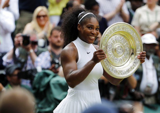 Serena Williams of the U.S holds her trophy after winning the women's singles final against Angelique Kerber of Germany on day thirteen of the Wimbledon Tennis Championships in London, Saturday, July 9, 2016.