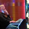 A man smokes while playing a slot machine at the Ocean Casino Resort in Atlantic City, N.J., on Feb. 10, 2022. A report issued Friday, June 17, 2022, by a Las Vegas gambling research company suggested that ending smoking in casinos will not result in significant financial harm to the businesses.