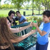 Hector Rosales, and Karina Bautista, of Illusion Graphics, film Sarita Rodriguez and her son Gus, 8, for an episode of "Growing With Gus" at  Gardens Park in Summerlin Tuesday, June 21, 2022. 