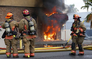 Flames shoot out from the entrance to a building in an industrial area west of the Palms Wednesday, June 22, 2022. A business owner, who declined to give his name, says the building has been vacant for years and was occupied by squatters.